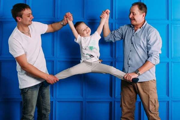 Grandfather father and son smiling and having fun