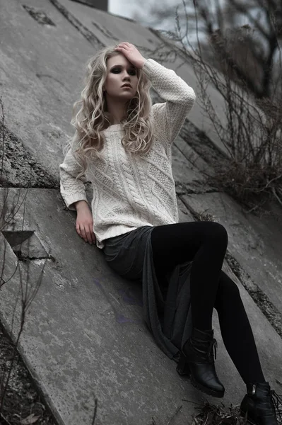 Mooie jonge blonde vrouw met blauwe ogen in de witte trui lange rok op voorjaar achtergrond, bomen, bos, lake. Koude sfeer. Mode, emotionele portret — Stockfoto