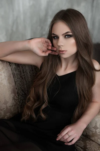 Menina com cabelos longos e bonitos e olhos fumegantes vestindo vestido de noite maxi preto. Estúdio — Fotografia de Stock
