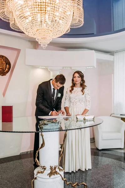 A beautiful bride and handsome groom during wedding registration — Stock Photo, Image