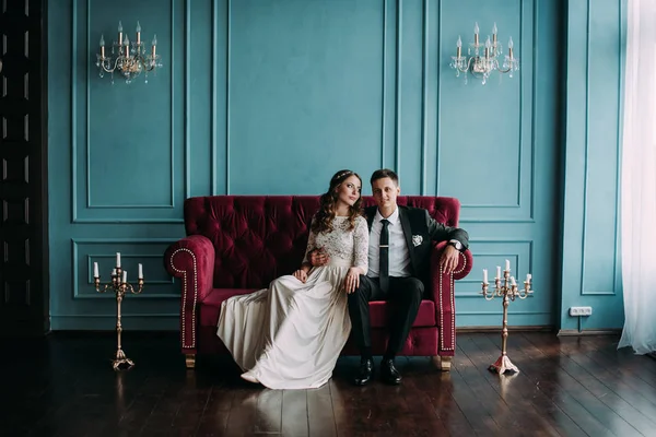 bir çift kişilik kanepe poz şirin düğün birkaç iç. Hey öp ve, birbirine bakarak elele sarılmak