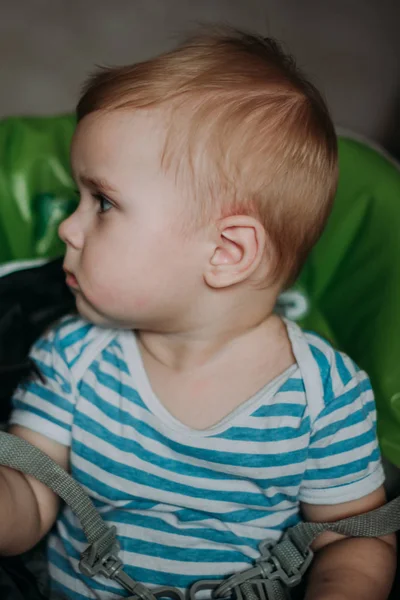 Serious 1-year infant boy during his first haircutting — Stock Photo, Image