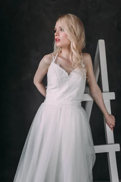 Portrait of a beautiful blond girl in image of the bride . Beauty face. Photo shot in the Studio on a grey background — Stock Photo, Image