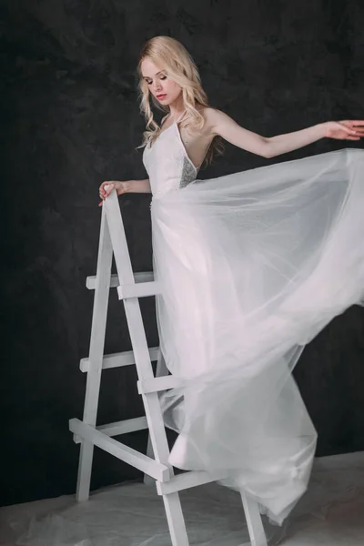 Portrait of a beautiful blond girl in image of the bride . Beauty face. Photo shot in the Studio on a grey background — Stock Photo, Image