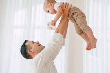 Yakışıklı baba ve oğul 1 yıl mutlu ve gülümseyen gün anda stüdyoda sarılma eğleniyor eski portresi. Dostu aile kavramı.