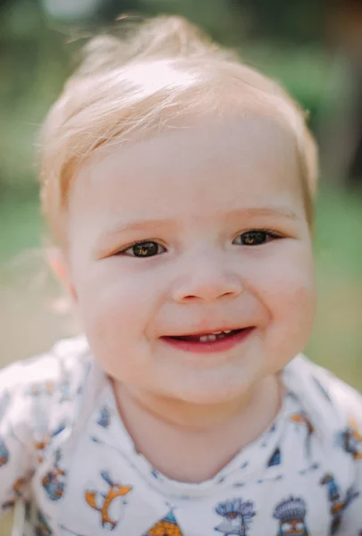 Serious 1-year infant boy during his first haircutting — Stock Photo, Image