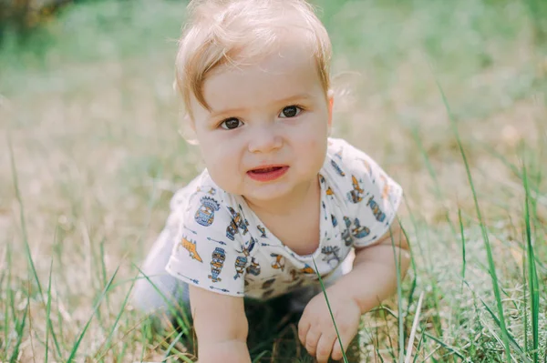 Serious 1-year infant boy during his first haircutting — Stock Photo, Image