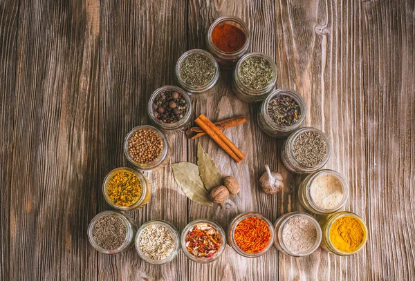 Olika färgglada sorters kryddor på rustika träbord, ovanifrån — Stockfoto