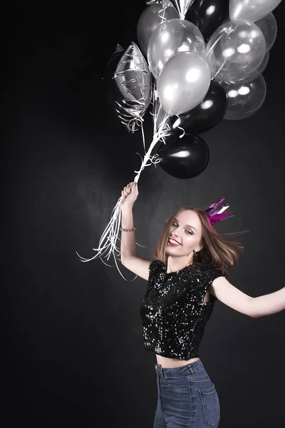 Close up fashion portrait of a young beautiful elegant girl with bright party make up in evening black sequin top. She is keeping silver stars balloons in her hand. Girl at the party. Retouched shot — Stock Photo, Image