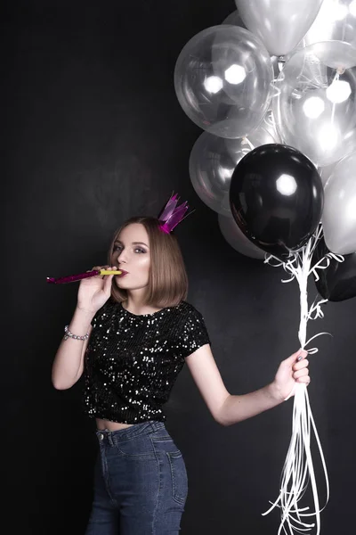 Close up fashion portrait of a young beautiful elegant girl with bright party make up in evening black sequin top. She is keeping silver stars balloons in her hand. Girl at the party. Retouched shot — Stock Photo, Image