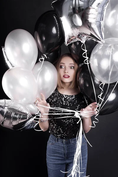 Close up fashion portrait of a young beautiful elegant girl with bright party make up in evening black sequin top. She is keeping silver stars balloons in her hand. Girl at the party. Retouched shot — Stock Photo, Image