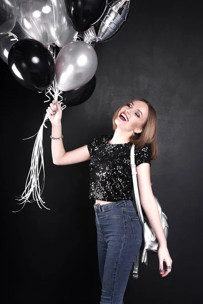 Close up fashion portrait of a young beautiful elegant girl with bright party make up in evening black sequin top. She is keeping silver stars balloons in her hand. Girl at the party. Retouched shot — Stock Photo, Image