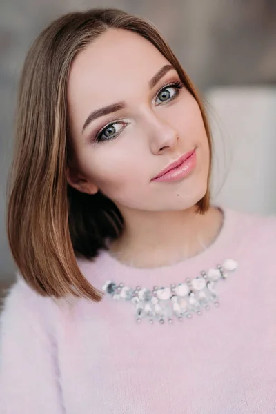 Soft photo of fresh young woman in pink tender sweater smiling. Pretty girl enjoying early sunny morning at home. — Stock Photo, Image