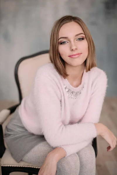 Soft photo of fresh young woman in pink tender sweater smiling. Pretty girl enjoying early sunny morning at home. — Stock Photo, Image