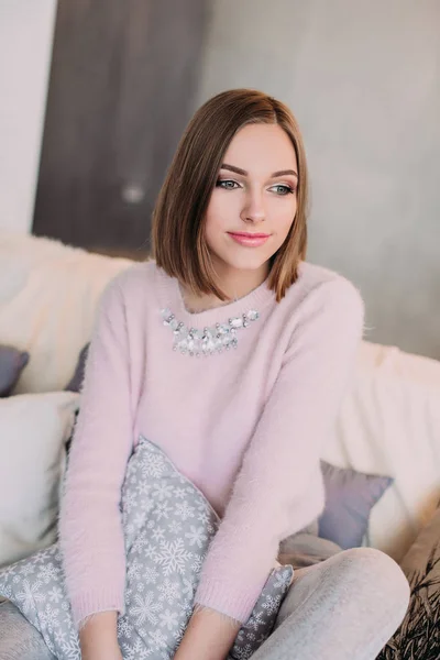 Soft photo of fresh young woman in pink tender sweater smiling. Pretty girl enjoying early sunny morning at home. — Stock Photo, Image