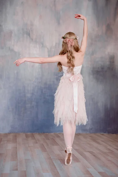 Belle gambe di giovane ballerina che ballano su sfondo bianco pavimento in legno, con spazio copia. Allenamento di danza. Bella ballerina di balletto snella e graziosa. Primavera e atmosfera romantica — Foto Stock