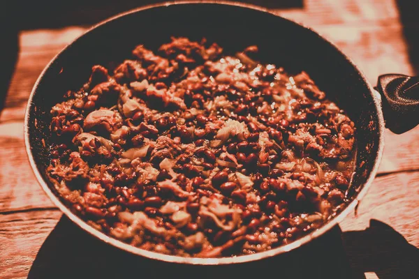 Food ingridients: meat, onion, ginger for recipe stewed beans with meat frying in a pen on a stove. Steps in cooking, process of preparing food. Concept of homemade healthy food. — Stock Photo, Image