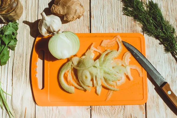 Food ingridients: garlic, ginger for recipe stewed beans with meat on wooden background. Steps in cooking, process of preparing food. Concept of homemade healthy food.