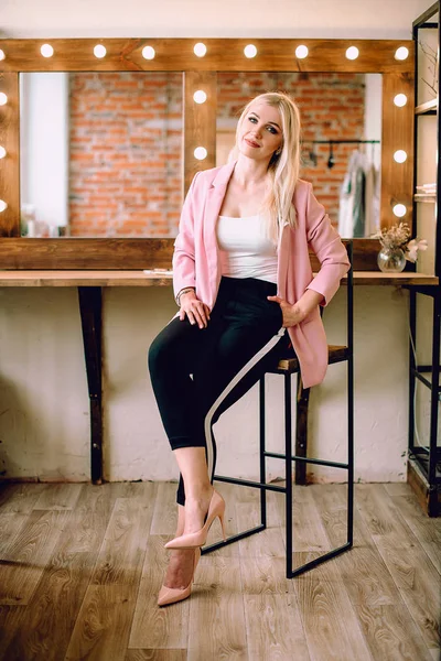 Visagist positive schöne blonde Frau posiert in der Nähe Spiegel in Make-up-Raum — Stockfoto