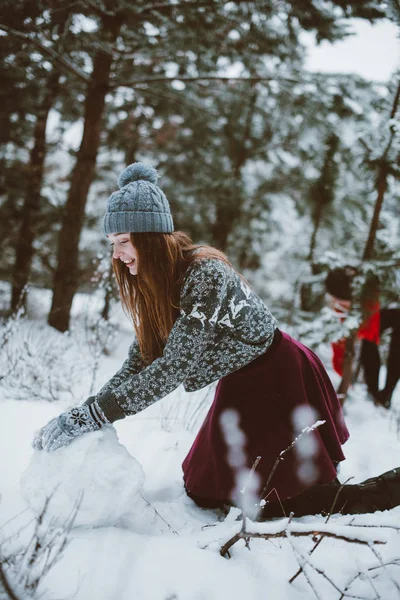 Two young teenage hipster girl friends together.Close up fashion portrait of two sisters hugs and having fun, make snowman in winter time forest, wearing sweaters and scarfs,best friends couple outdoo — Stock Photo, Image