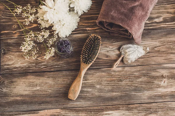 Haircare concept. Natural sandalwood comb closeup on wood background