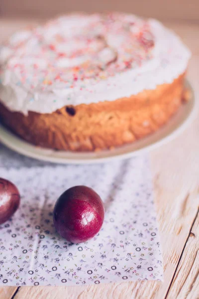 Пасхальный стол с традиционными пасхальными тортами и пасхальными яйцами с цветущей веткой дерева — стоковое фото