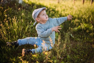 Erkek bebek 1-2 yaşında yazın doğayı keşfediyor, eğleniyor.