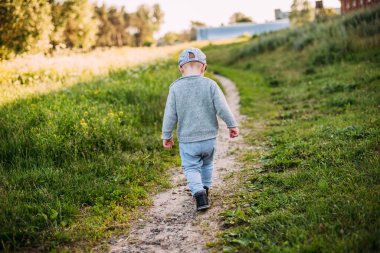 Erkek bebek 1-2 yaşında yazın doğayı keşfediyor, eğleniyor.