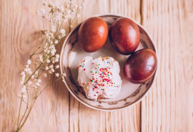 Geleneksel Paskalya pastaları ve çiçek açan ağaç dallı Paskalya yumurtaları olan Paskalya masası, din.