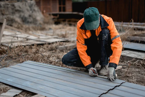 Young construction worker outdoors. Renovation background.