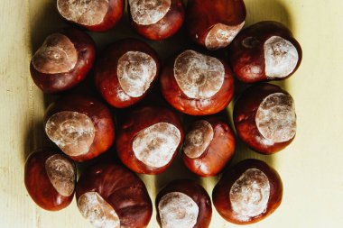 Olgun kestaneler eski ahşap masa ve çuval peçeteler fotokopi alanı ile yakın.