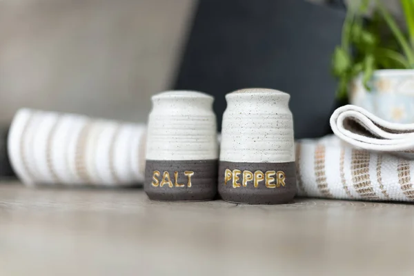Salt and Pepper shakers on the kitchen working space.