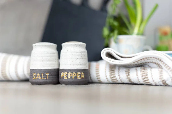 Salt and Pepper shakers on the kitchen working space.