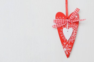 Red and white handmade hearts on white background. Copy space.