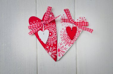 Red and white handmade hearts on white background. Copy space.