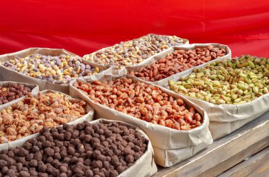 Assorted nuts in paper boxes for sale in the market. Selective focus. Copy space.