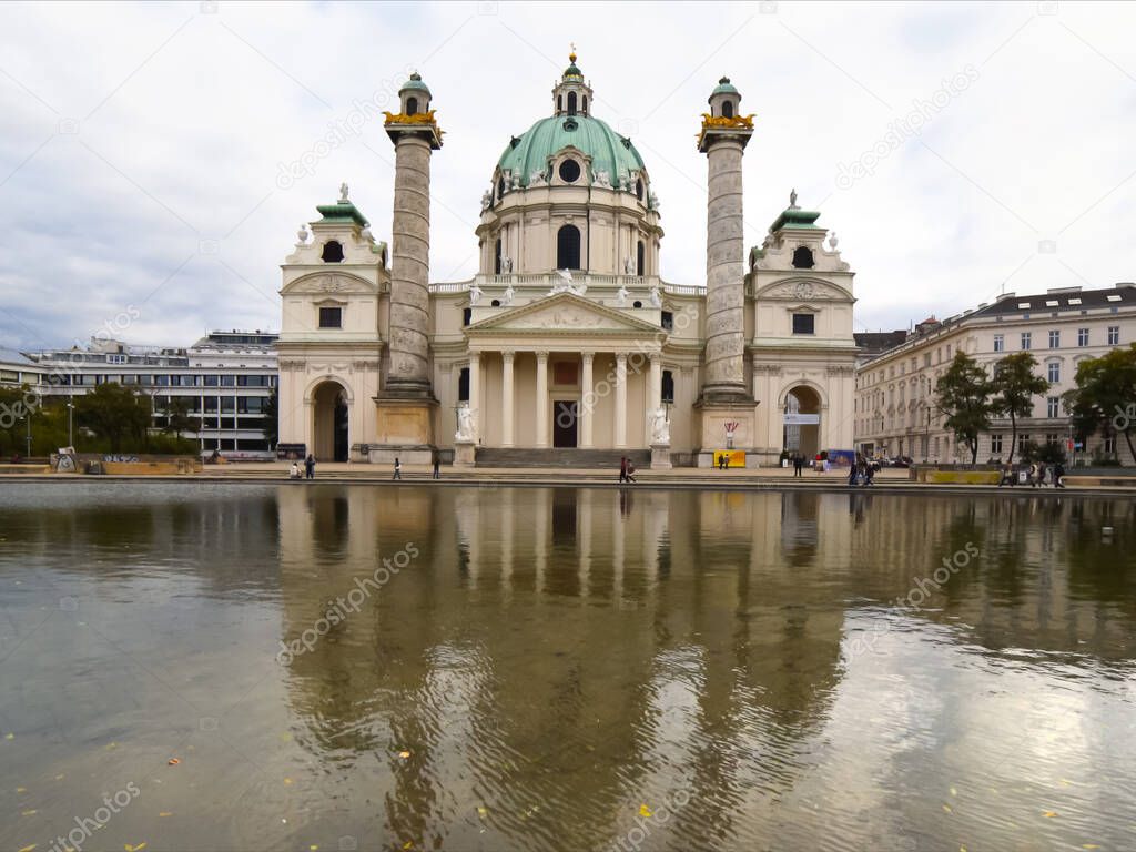 ultra wide afternoon shot of st charles church and pool in vienna, austria