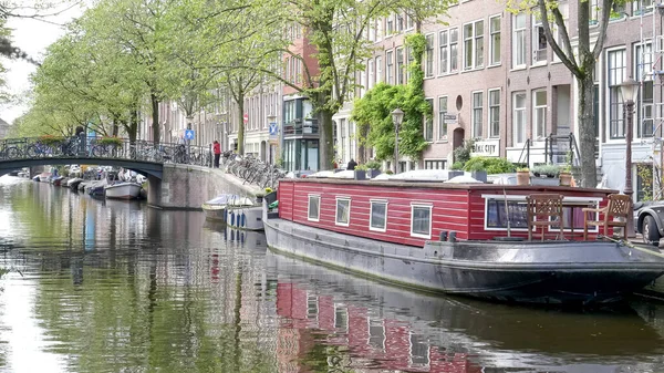 AMSTERDAM, PAÍSES BAJOS-OCTUBRE, 12, 2017: barco casa atado en un canal en Amsterdam — Foto de Stock