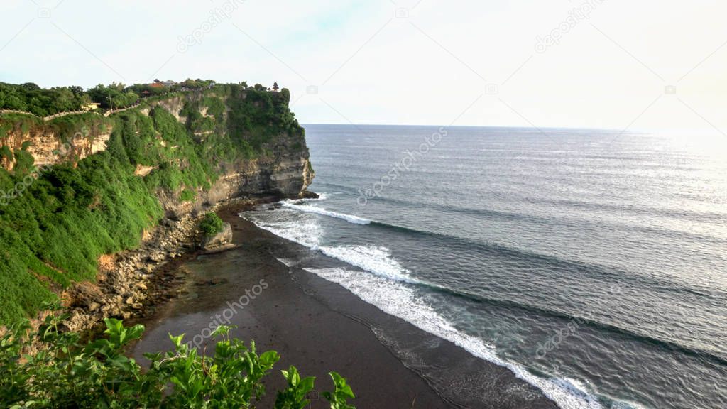 afternoon shot of the cliffs and surf at uluwatu temple on bali