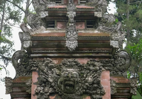 an elaborately carved temple gate at tirta empul on bali