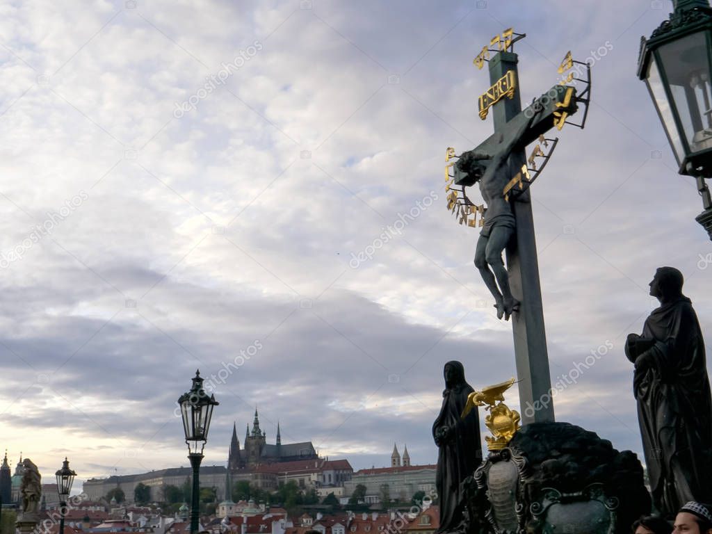 dusk shot of a crucifix on charles bridge in prague