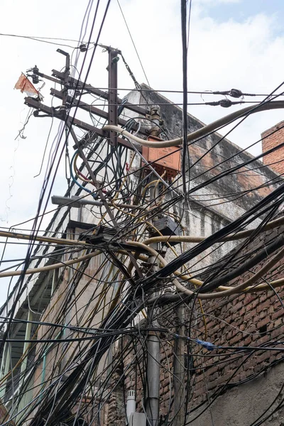 tangle of electrical cables on a street of chandni chowk in old delhi