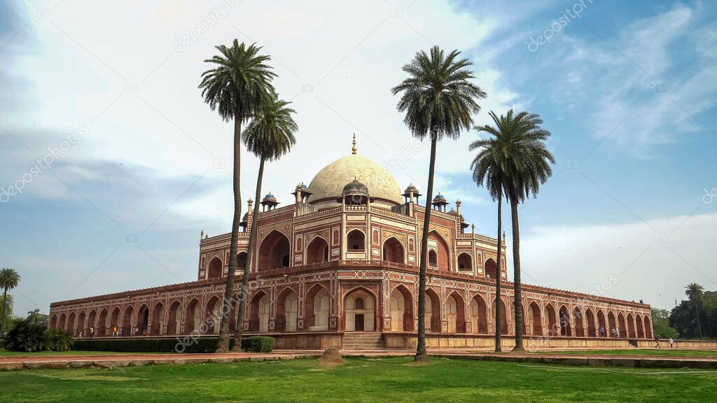 wide view of humayuns tomb and palm trees in delhi