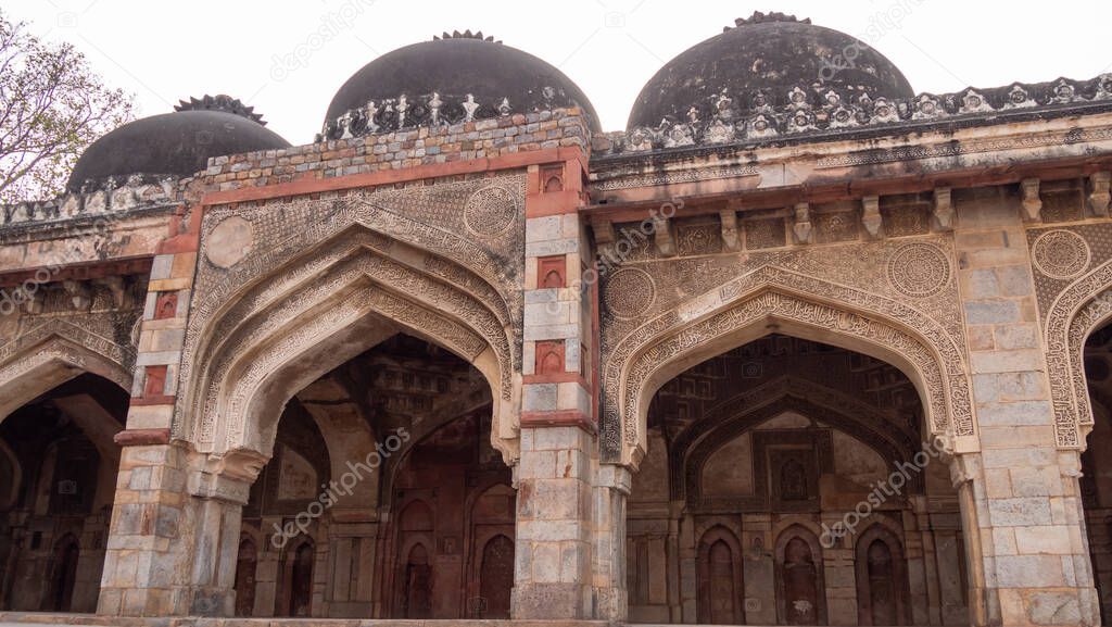 arches of bara gumbad at lodhi gardens in new delhi, india