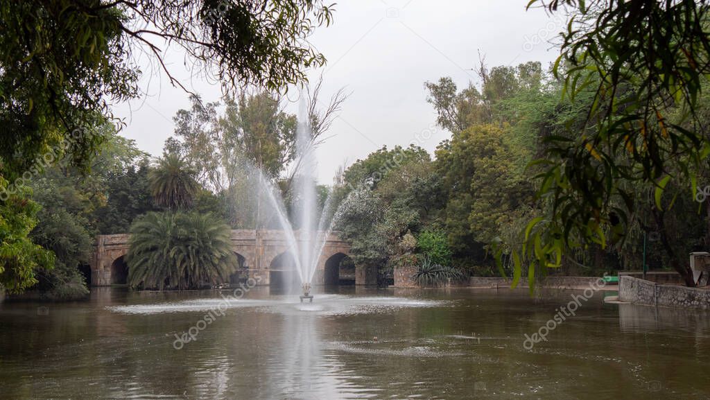 a fountain and pond at lodhi garden in delhi