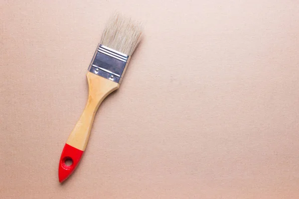 Closeup of one paint brush on wooden table — Stock Photo, Image