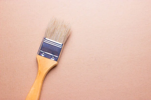 Closeup of one paint brush on wooden table — Stock Photo, Image
