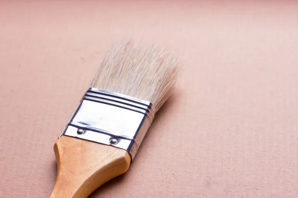 Closeup of one paint brush on wooden table — Stock Photo, Image