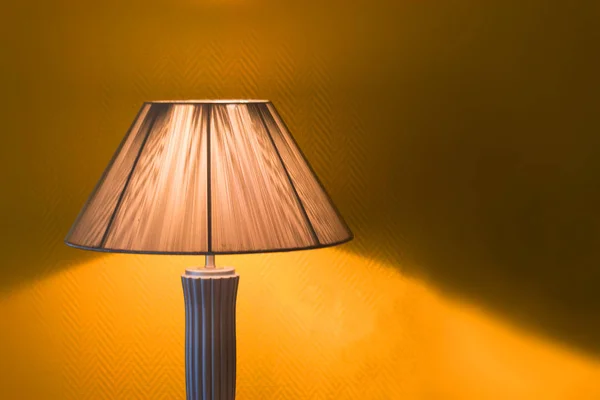 Nice luminous desk lamp on ginger background Stock Image