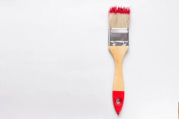 Construction brush with red paint — Stock Photo, Image